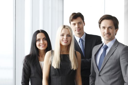 Happy business team of coworkers in office