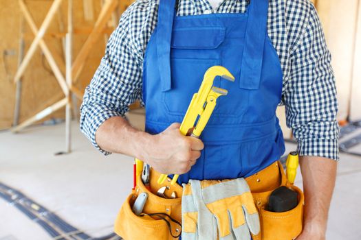 portrait of workman with adjustable wrench