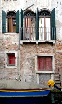 canal and boats with ancient architecture in Venice, Italy