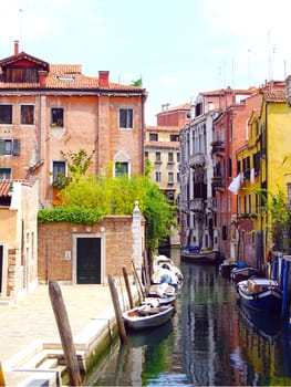 canal and boats with ancient architecture in Venice, Italy