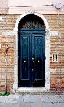 door on old brick wall building architecture, Venice, Italy