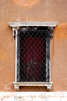 old window with metal frame of old house building in Venice, Italy