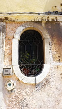 oval shape window of old house building in Venice, Italy