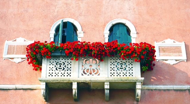 two doors and terrace with red flowers  building architecture, Venice, Italy