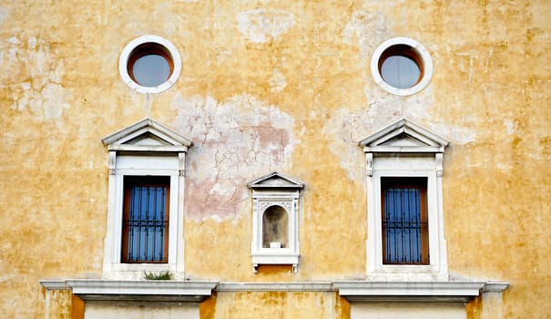 Windows on decay wall building architecture, Venice, Italy