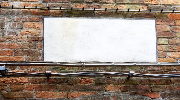 blank sign on brick wall in Venice, Italy