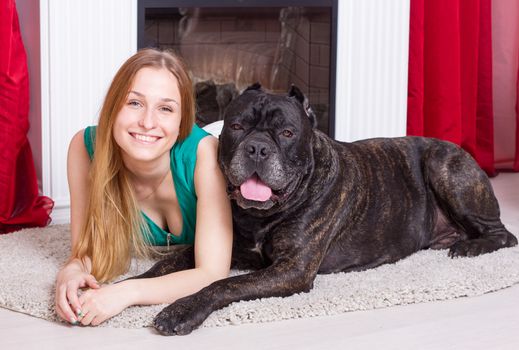 girl is at home  with his big dog Cane Corso