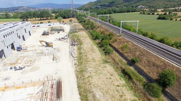 Building site near railway, aerial view.