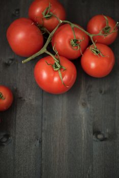 Fresh tomatoes on vintage wooden table