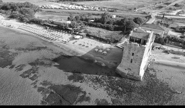 Torre Mozza, Italy. Overhead view of ancient tower and public beach.