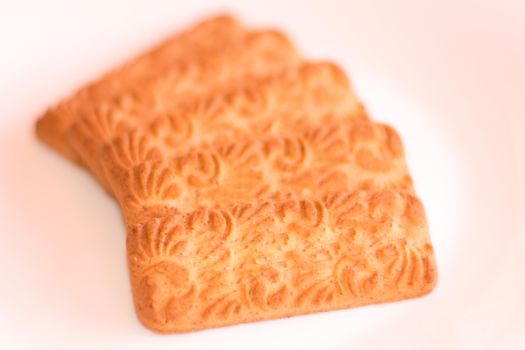 Five biscuits put in a row, isolated on white background.