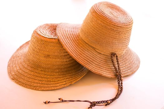 Two fashionable straw hats isolated on white.