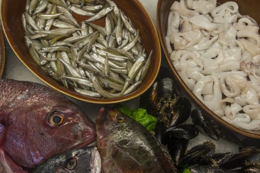 wooden bowls with fresh fish and seafood