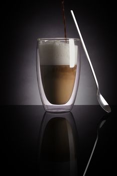 Caffe latte on dark background. Culinary coffee drinking.