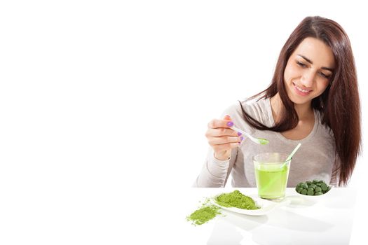Detox. Beautiful girl with green drink in hand isolated on white. Spirulina, chlorella and wheatgrass. Healthy lifestyle, detox.
