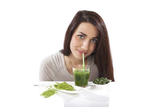Detox. Beautiful girl with green drink in hand isolated on white. Spirulina, chlorella and wheatgrass. Healthy lifestyle, detox.