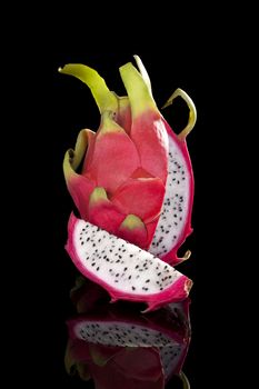 Luxurious dragon fruit isolated on black background. Tropical fruit, luxurious minimal style. 