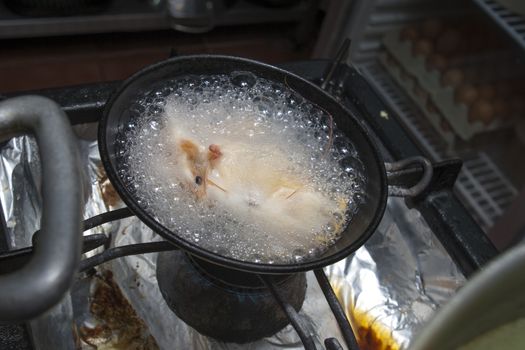 shrimps boil in pan on restaurant kitchen