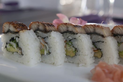 set of sushi rolls served with wasabi and ginger