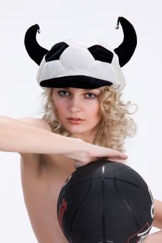 Young attractive blonde woman ina fan hat holding a ball