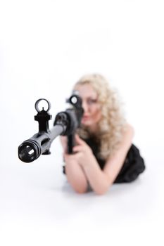 Young blonde woman dressed in military style with weapon