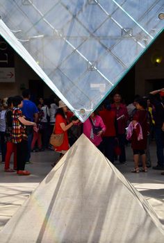 Paris, France - May 13, 2015: Tourists visit Inside the Louvres pyramid on May 13, 2015 in Paris. Louvre is one of the biggest Museum in the world, receiving more than 8 million visitors each year. 