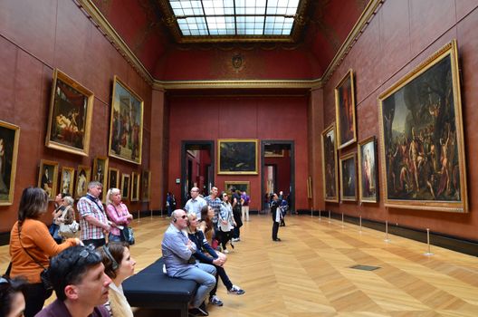 Paris, France - May 13, 2015: Visitors visit Rubens paintings in Louvre Museum, Paris, France. With 8.5 m annual visitors, Louvre is consistently the most visited museum worldwide.