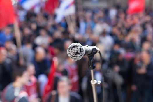 Microphone in focus against blurred audience