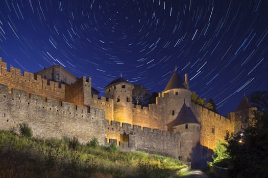 Star trails above the medieval fortress and walled city of Carcassonne in the Languedoc-Roussillon region of southwest France. Founded by the Visigoths in the 5th century, it was restored in 1853 and is now a UNESCO World Heritage Site.