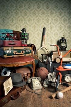 Assorted vintage items in the attic with retro wallpaper background.