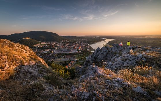 Man and Woman Looking at View of Small City of Hainburg an der Donau with Danube River from Braunsberg Hill at Beautiful Sunset