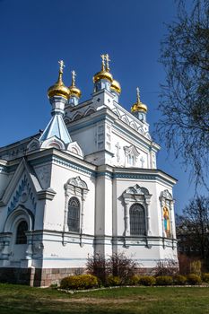 Side view of Orthodox Ss Boris and Gleb Cathedral in Dougavpils, Latvia, on blue sky background.