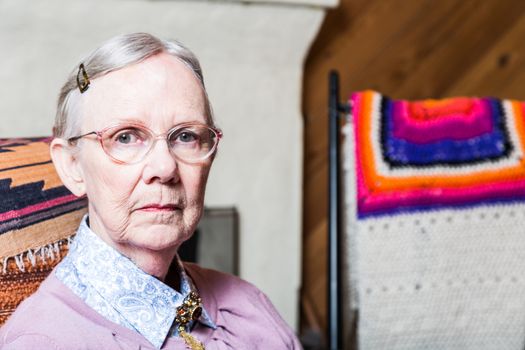 Elderly woman in pink sweater seated in living room