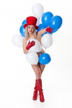 Young nude woman with a bunch of white and blue air balloons on isolated background