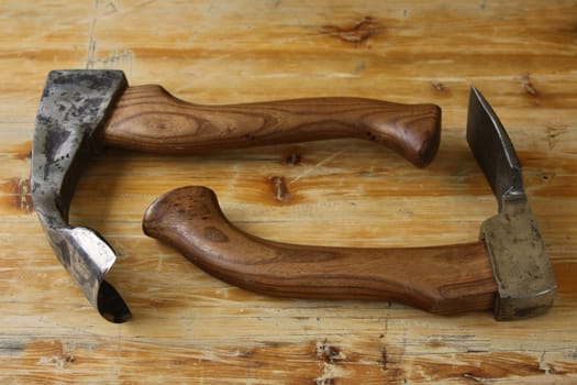 tools of a carpenter - axe and chisel on wood background