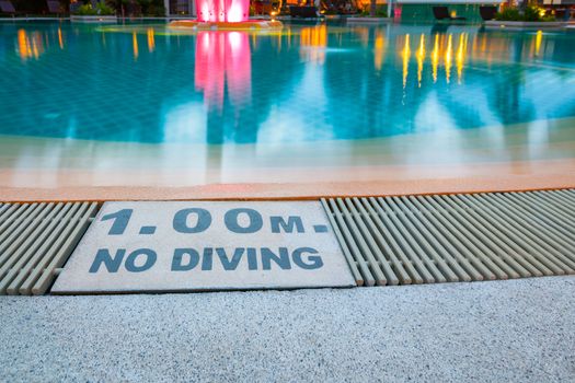 warning sign "1.00m No Diving" at Swimming pool of luxury hotel