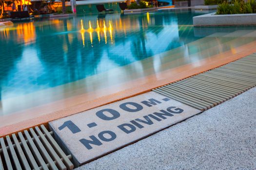 warning sign "1.00m No Diving" at Swimming pool of luxury hotel