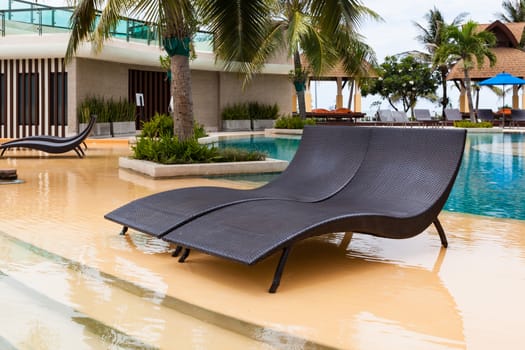 Beach chairs near swimming pool in hotel