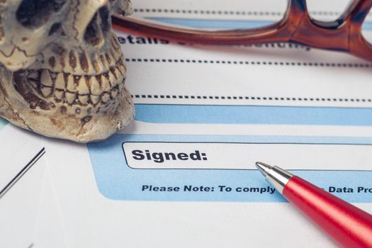 Signature field on document with pen and skull signed here; document is mock-up