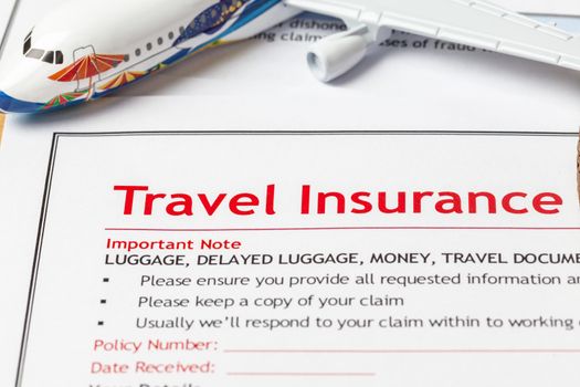 Travel Insurance Claim application form on brown envelope, business insurance and risk concept; document and plane is mock-up