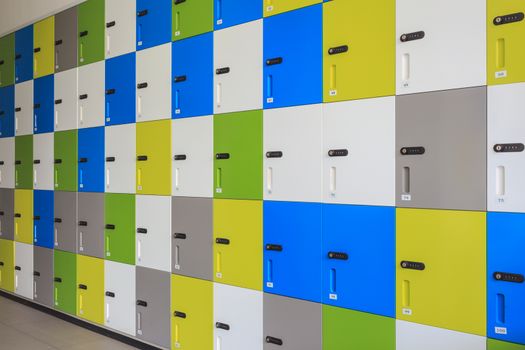 row of colorful lockers and security password code on door for safety concept