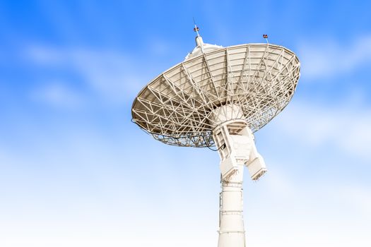 satellite dish antenna radar big size isolated on blue sky background