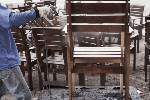 worker or carpenter, hand splash painted or repair, wooden chair