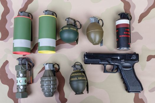 All explosives, weapon army,standard time fuze, hand grenade and gun on camouflage background, top view