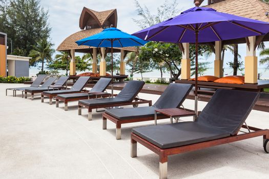 Beach chairs near swimming pool in hotel