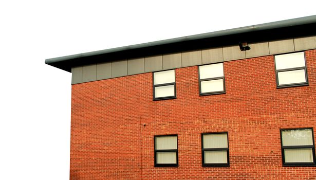 Modern office building exterior on a white background with copy space.