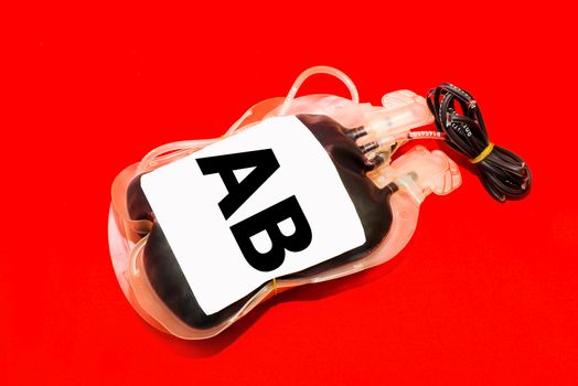 Close up bag of blood and plasma group AB isolated on Red background