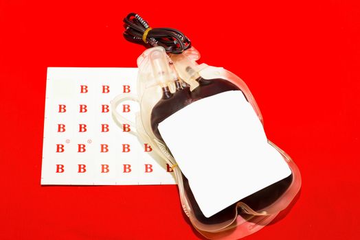 Close up bag of blood and plasma group B isolated on Red background