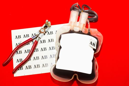 Close up bag of blood and plasma group AB isolated on Red background