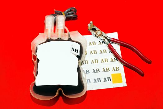 Close up bag of blood and plasma group AB isolated on Red background